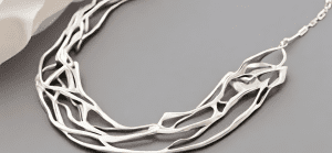 Feature a contemporary silver jewelry piece, emphasizing its sleek design.